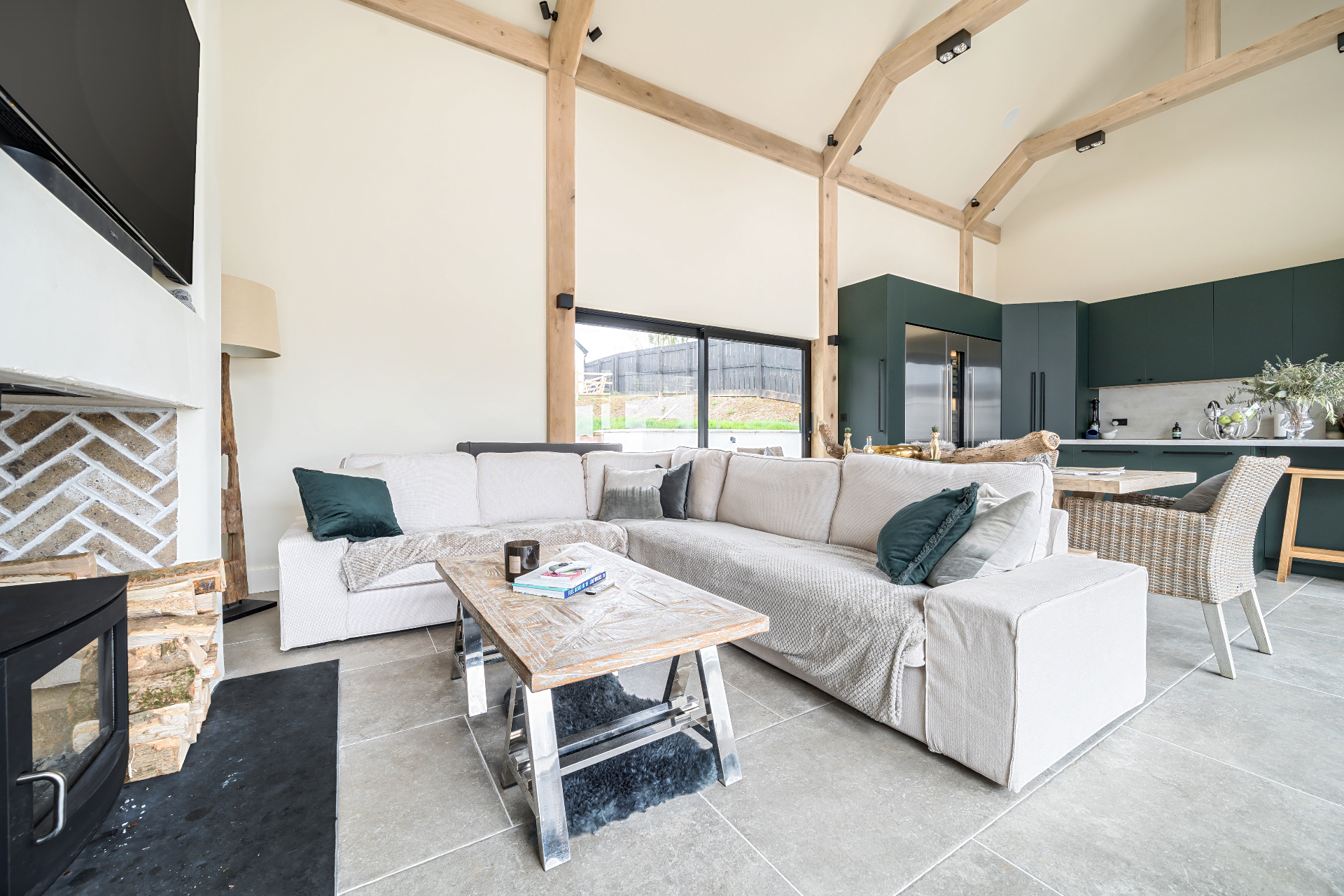 Contemporary open-plan living space with vaulted oak frame and modern kitchen