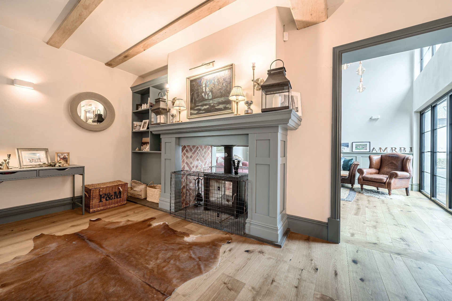 Traditional interior with beamed ceiling, period fireplace and oak floors